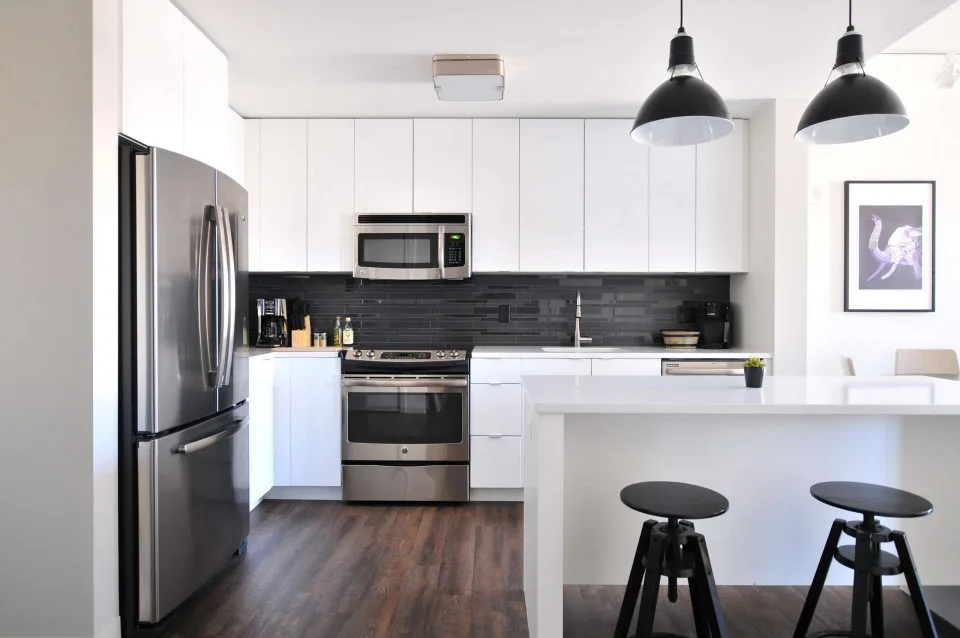 a kitchen with stainless steel appliances and white cabinets