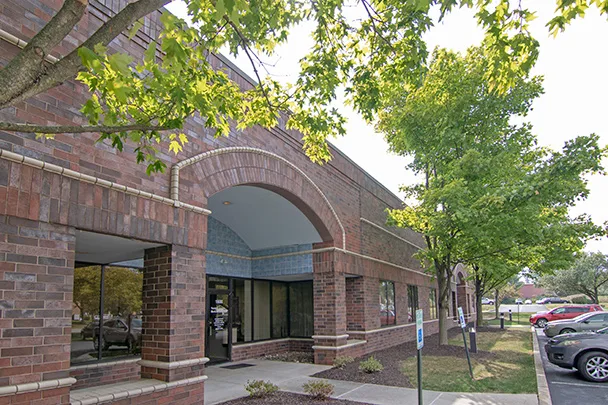 a brick building with a sign that says no parking