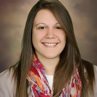 a woman with long hair and a scarf around her neck is smiling for the camera .