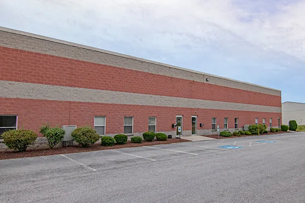 a large brick building with a handicapped parking spot in front of it