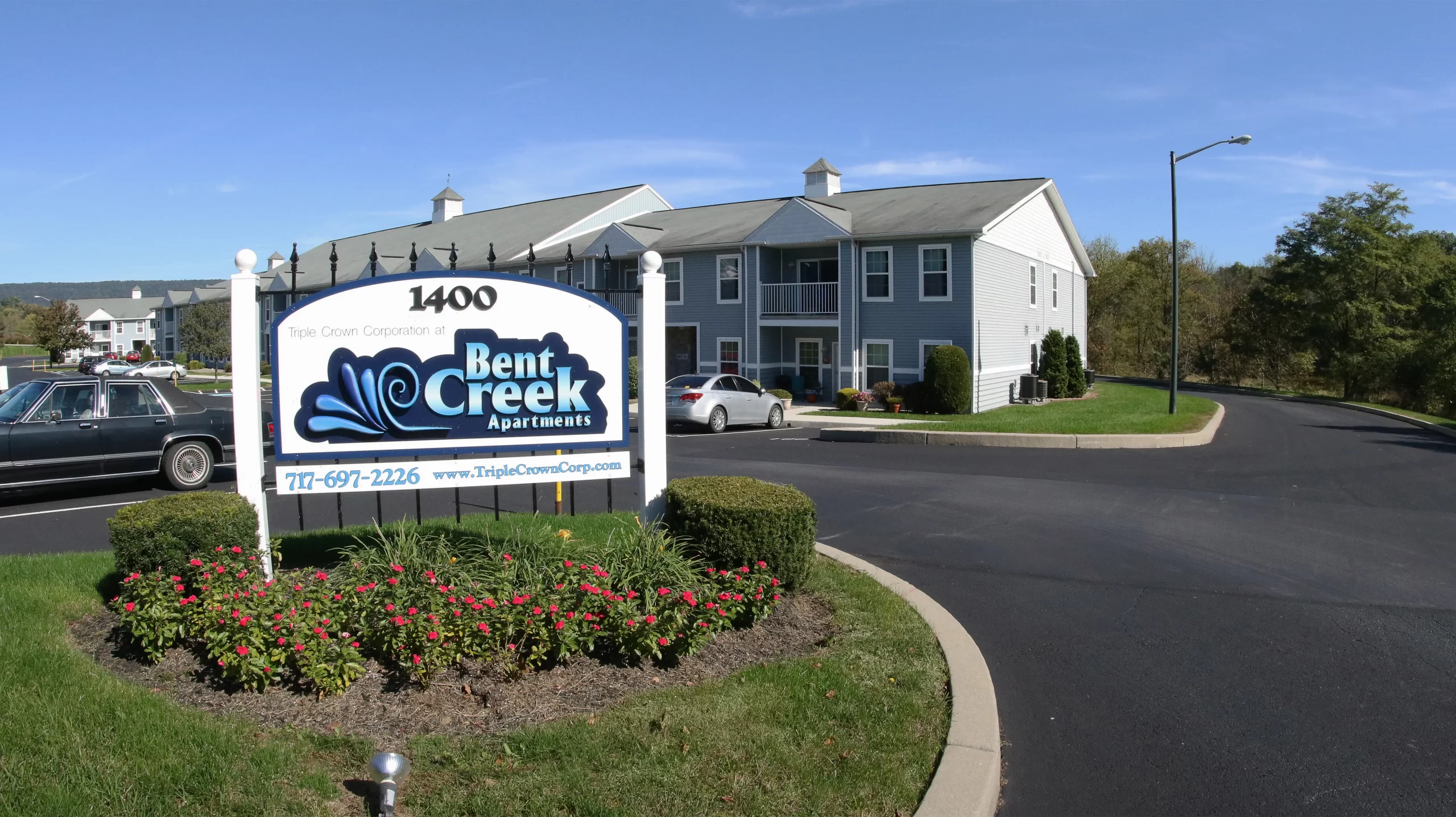 a bent creek apartments sign in front of a building