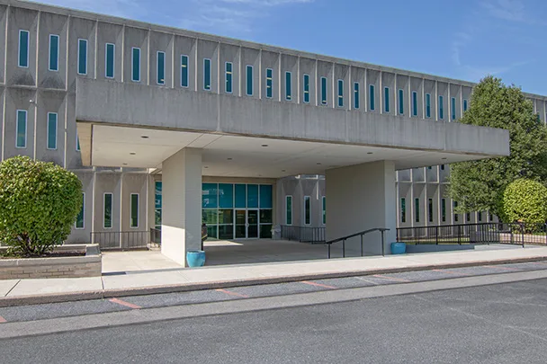 a large building with a lot of windows and a ramp