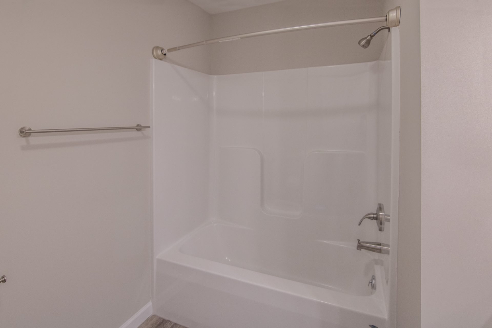 a bathtub in a bathroom with a shower head