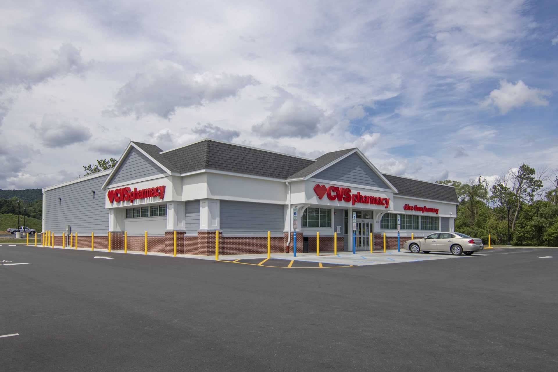 A CVS Pharmacy with a Car Parked in Front of It